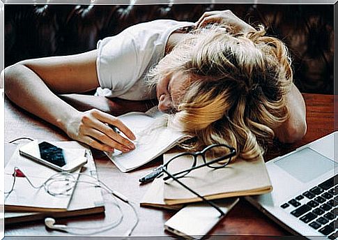 Exhausted woman at desk