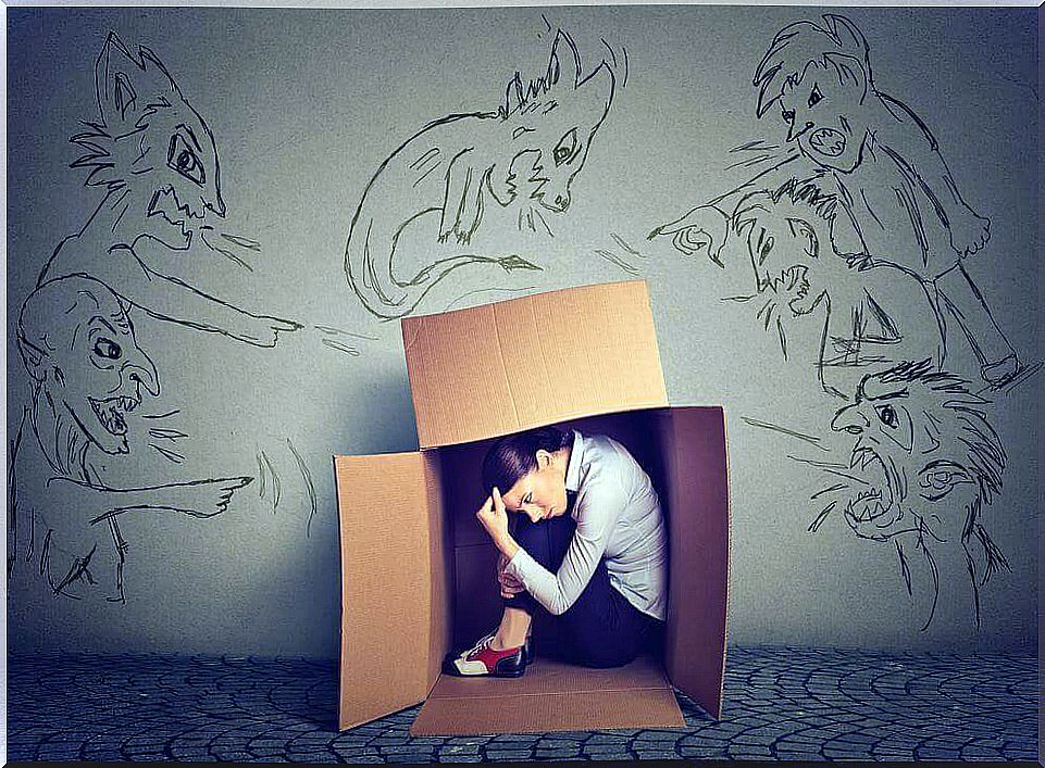 Woman hiding in a box for criticism