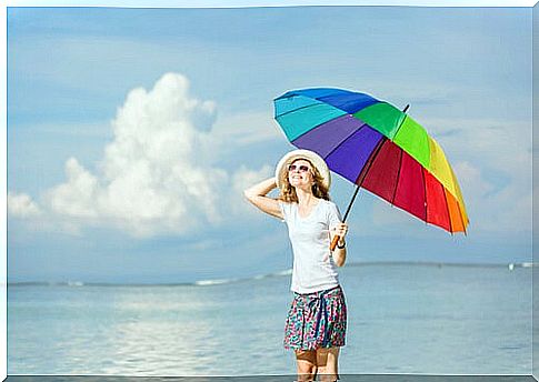 Happy woman with colorful umbrella