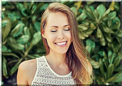 Woman with eyes closed smiling