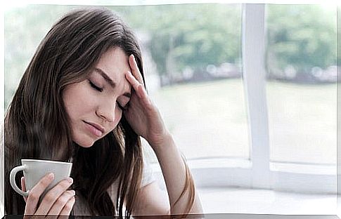 Anxious woman having tea thinking of coping with the pandemic when you are highly sensitive