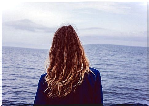 Woman looking at the horizon thinking about her dreams
