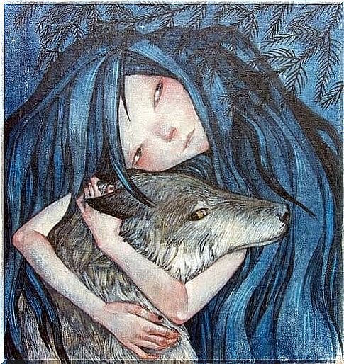 Woman hugging a wolf thinking about magic