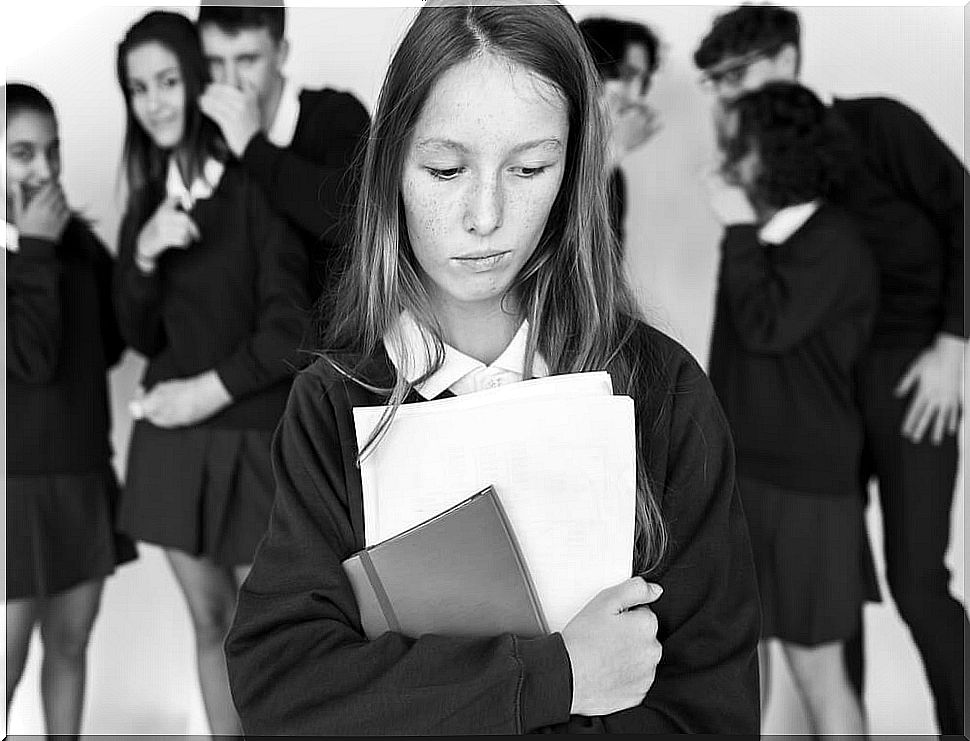 Girl suffering bullying carrying the agenda in her hands