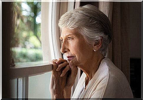Woman with dementia looking out the window