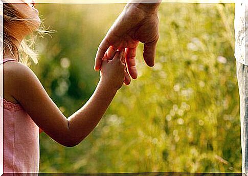 Little girl holding her mother's hand while saying thank you dads
