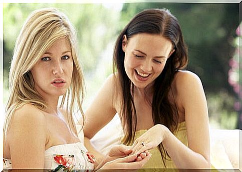 Girl feeling envious of the other person for her ring